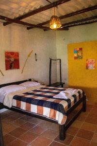 a bedroom with a bed in a room at HOTEL CAMPESTRE ABRAZO DEL ANGEL in Aratoca