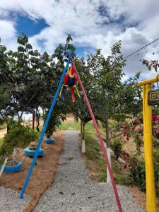 a child on a swing at a playground at HOTEL CAMPESTRE ABRAZO DEL ANGEL in Aratoca