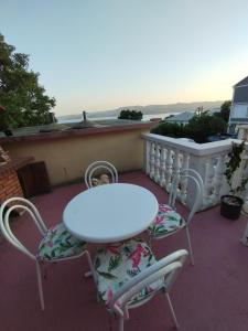 a white table and two chairs on a balcony at Soba Ivanka Nikšić in Karlobag