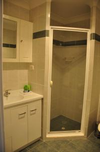 a bathroom with a shower and a sink at Bribie Island Square in Bongaree