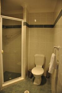 a bathroom with a toilet and a shower at Bribie Island Square in Bongaree