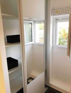 a closet with two windows in a room at Studio(1) cosy, 2 pers aéroport Marseille in Marignane