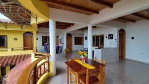 a dining room and kitchen with a table and chairs at Hotel Cielo Azul in Atacames