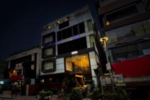 a building with a light on the side of it at Collection O Hotel 29 Church's Inn Near Cubbon Park in Bangalore