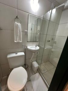 a bathroom with a toilet and a sink and a shower at Pousada Colonial Chile in Salvador +68 photos