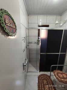 a bathroom with a shower with a black door at Casa térrea em meio ao verde! in Encantado +20 photos