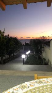 a view of a sunset from a house with street lights at Casa vacanze Gemini in Triscina