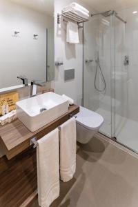 a bathroom with a sink and a shower and a toilet at La Casa de las Flores in Cartagena