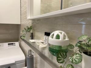 a kitchen counter with a green and white mixer on it at R59 Apartman with free parking in Pécs +12 photos
