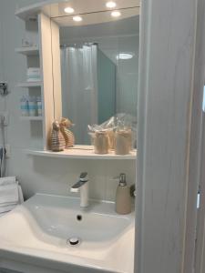a bathroom with a sink and a mirror at Apartment GAVIOTA Krk in Krk