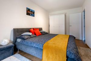 a bedroom with a large bed with orange pillows at Superbe Loft Center of Saverne Bike Parking in Saverne