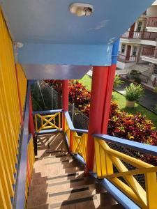 a colorful house on a balcony with a garden at Coco Mango Suites in Portsmouth