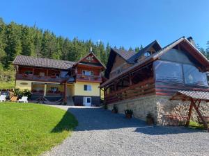 a large building with a large window on the side of it at Pensiunea Maria in Lacu Rosu