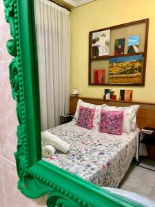 a bedroom with a bed with a green mirror at Hostal Alvarez in León