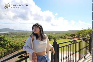 a woman standing on a balcony with a view at The South-Dawn in Hengchun
