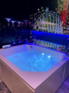 a hot tub with a view of a city at night at Apartman S&V 4 Wellness & Spa Barda in Sarajevo