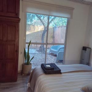 a bedroom with a bed and a large window at El Olivo in Chacras de Coria