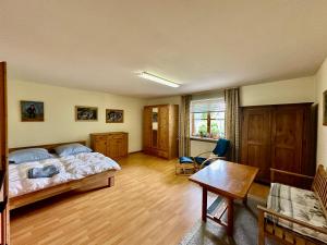 a bedroom with a bed and a table in it at Bayerischer Wald - Balbersdorf in Waffenbrunn