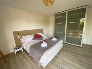 a bedroom with a bed with two boxes on it at Résidence Terra Théa in Propriano