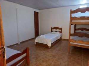 a bedroom with a bunk bed and a ladder at Pousada Nordestino próx ATALAIA in Salinópolis