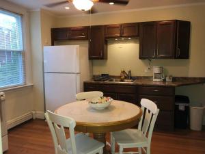 a kitchen with a table with chairs and a white refrigerator at Walk to Downtown Salem in Salem