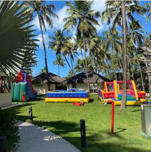 a park with a bunch of play equipment in the grass at JATIÚCA SUITES RESORT - FLAT VISTA MAR in Maceió