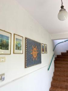a staircase in a house with paintings on the wall at Villa Mance in Berat