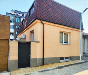 a house with a brown roof and a garage at Sun-kissed Varna Getaway in Varna City