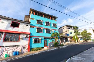 a blue building on the side of a street at Moonlight, Galápagos in San Cristóbal