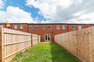 ダービーにあるBeautiful New House in Derby For up to 5 Guests, Suitable for Families Contractors NHS Staff etcの塀が前に建つレンガ造り