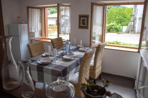 a dining room table with chairs and a table cloth at Casa Natura e Quiete in Stregna