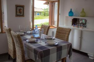 a dining room with a table with chairs and a table cloth at Casa Natura e Quiete in Stregna