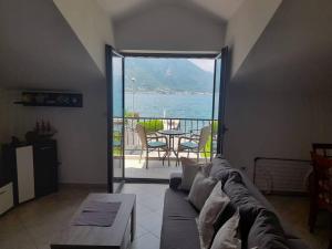 a living room with a couch and a view of the water at Summer Apartment in Kotor