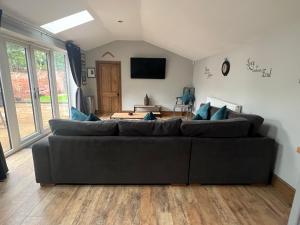 a living room with a couch and a tv at York House in Retford
