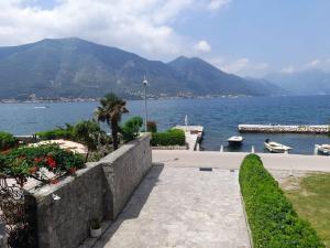 a stone walkway next to a large body of water at Summer Apartment in Kotor