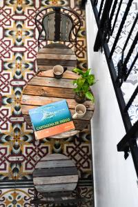 a book and a plant sitting on a wall at Casa de la Cruz in Cartagena de Indias