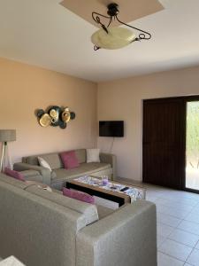 a living room with a couch and a table at House with Garden in Peratata - 10' from City Center in Peratáta