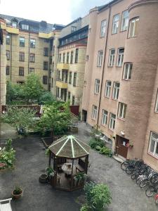 un patio con cenador frente a los edificios en Rum med eget badrum och stort, delat kök,centralt i Malmö en Malmö