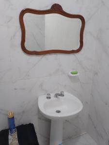 a bathroom with a sink and a mirror on the wall at casa pileta patio indio froilan estadio unico madre de ciudades in Santiago del Estero