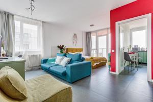 a living room with a blue couch and a bedroom at Dodi Studio Compact in Arad