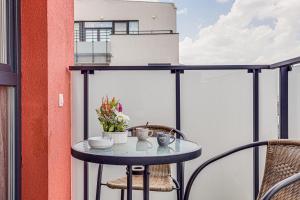 a small table on the balcony of a building at Dodi Studio Compact in Arad