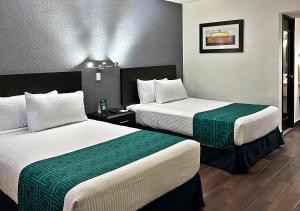 a hotel room with two beds in a room at InHouse Obregón in Ciudad Obregón