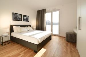 a bedroom with a bed and a large window at Lunas Appartements Essen in Essen
