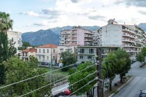 a city street with buildings and mountains in the background at Central Cozy Apartment 3 in Sparta