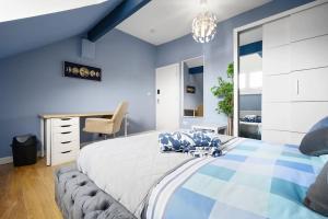 - une chambre bleue avec un lit et un bureau dans l'établissement Mega Flat Near Arndale City Centre, à Manchester