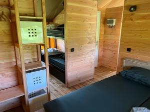 a small room with a bed and bunk beds at Safaritent 1 in Swalmen