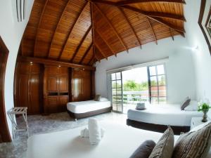 a bedroom with two beds and a large window at Hotel Koray in San Andrés +25 photos
