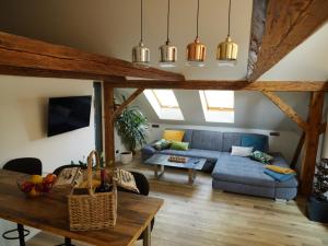 a living room with a blue couch and a table at Apartmán Danuše in Česká Lípa