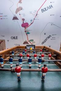 a group of figurines standing on a pool table at Casa Voyage Hostel in San Pedro de Atacama