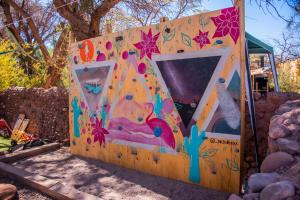 a large play structure with a climbing wall at Casa Voyage Hostel in San Pedro de Atacama